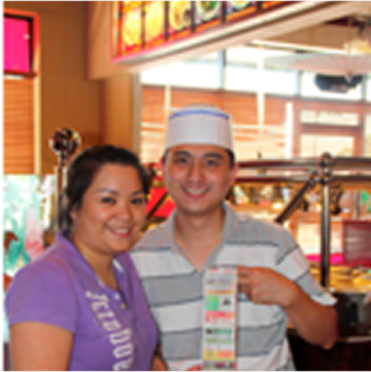 Two people smiling in a restaurant.
