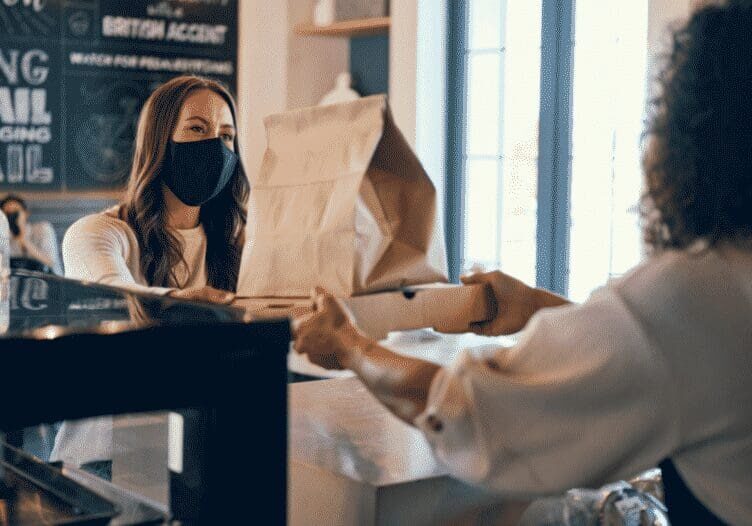 Customer receiving food in a cafe.